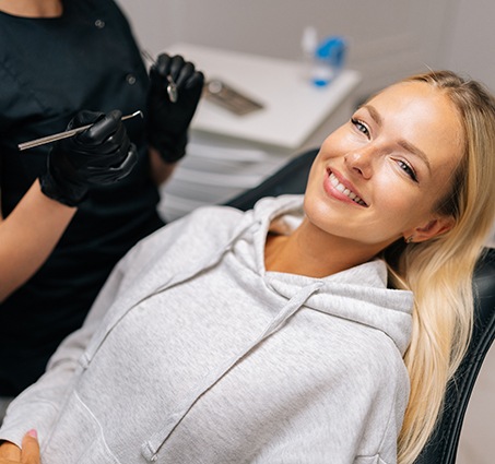 Patient reclined in treatment chair smiling