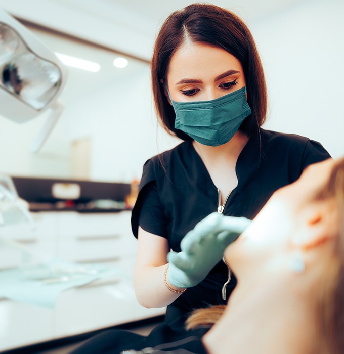 Dentist examining patient's teeth