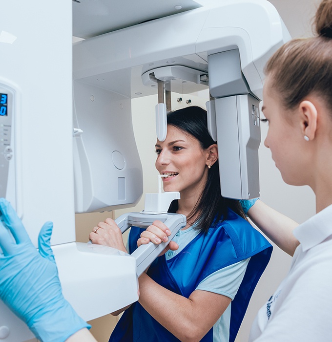 a woman having a cone beam CT image taken of her face