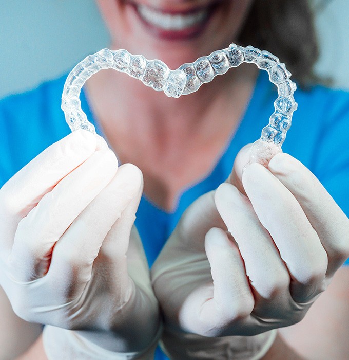 Invisalign works by straightening the teeth with clear aligners in Muskegon, MI